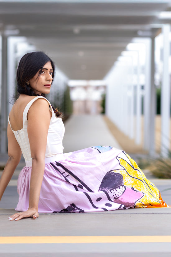 Model wearing POISE abstract wearable art midi skirt by Ojasi, luxury designer statement skirt for modern women