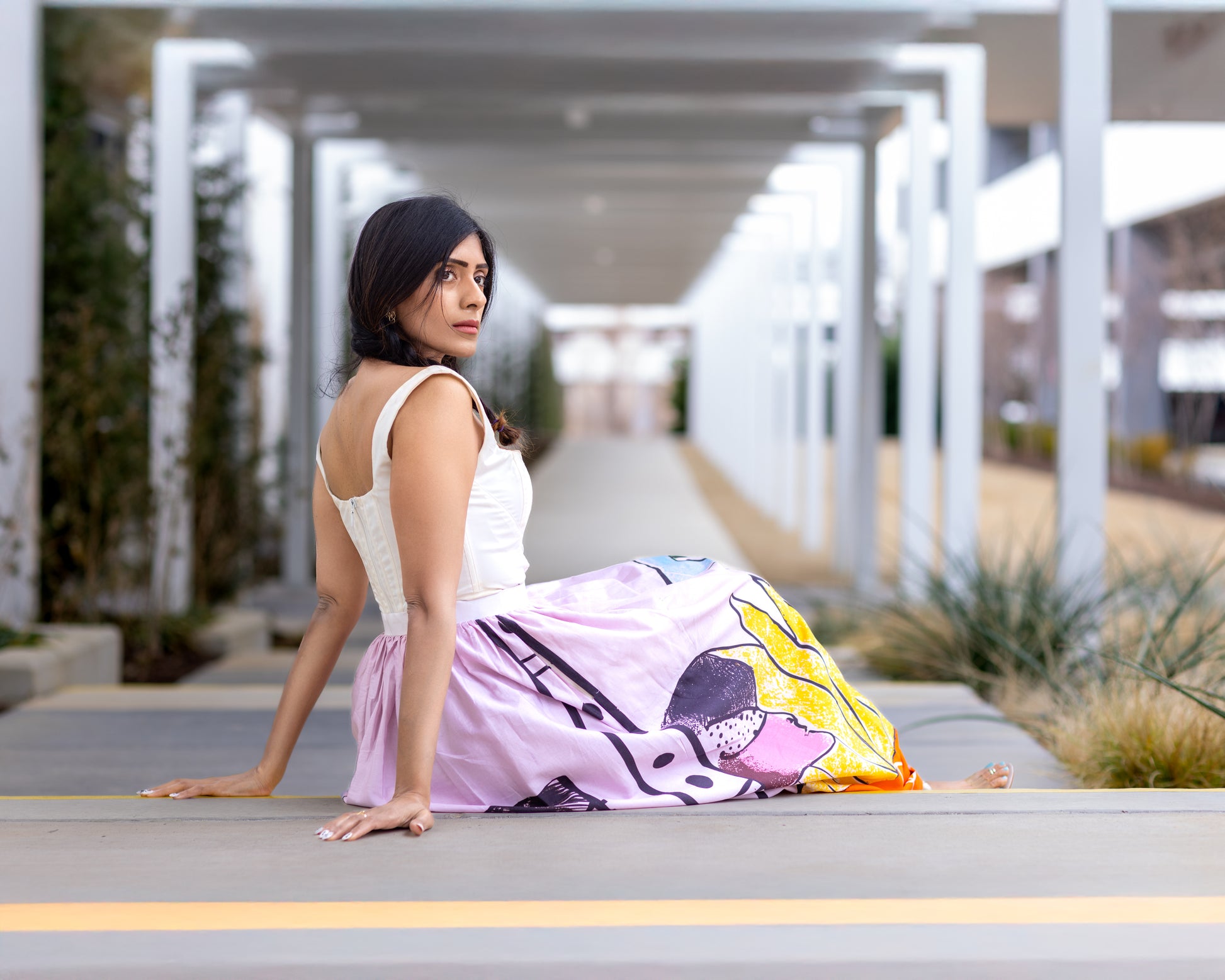 Model wearing POISE abstract wearable art midi skirt by Ojasi, luxury designer statement skirt for modern women