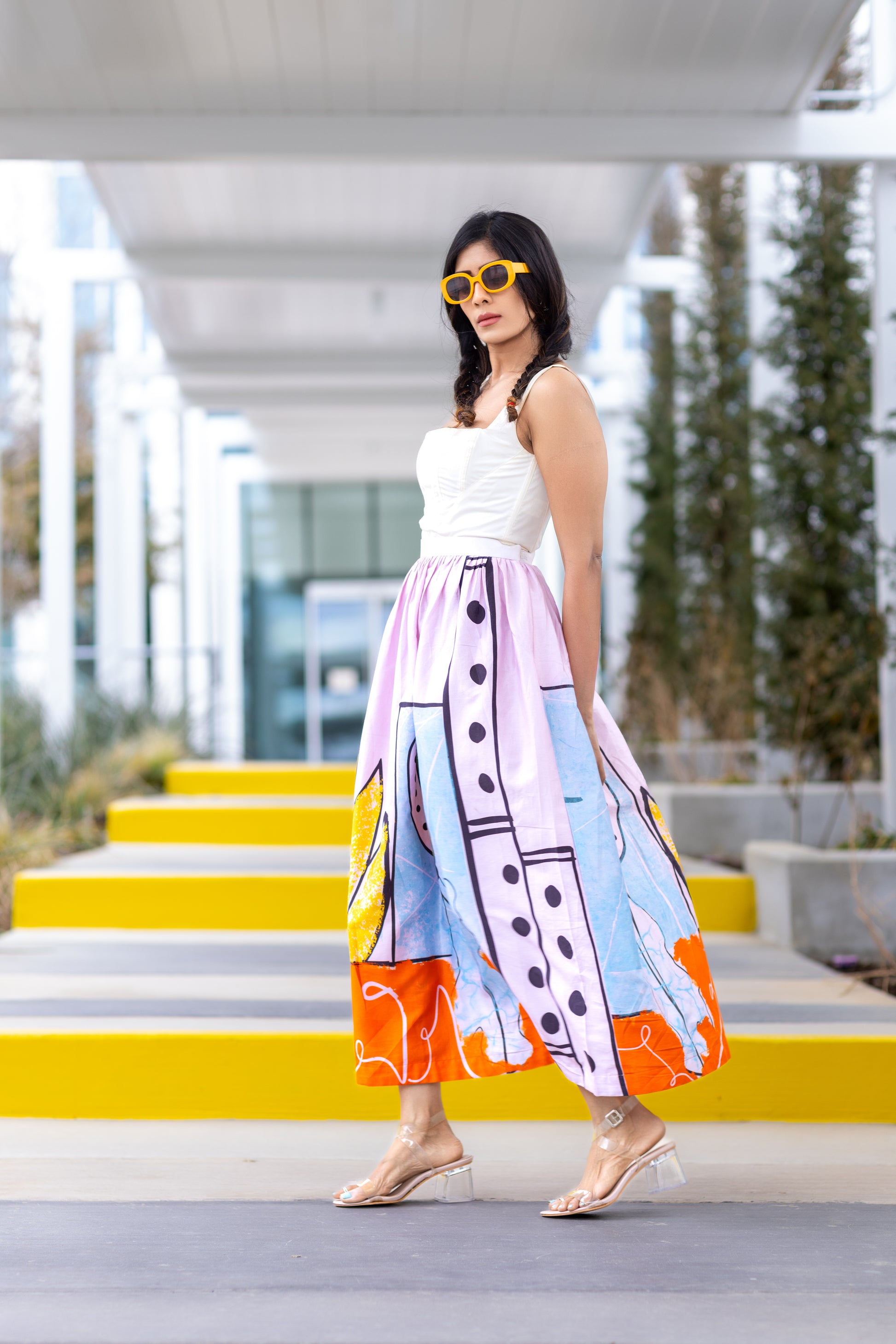 Model wearing POISE. abstract wearable art midi skirt by Ojasi, luxury designer statement skirt in editorial street style