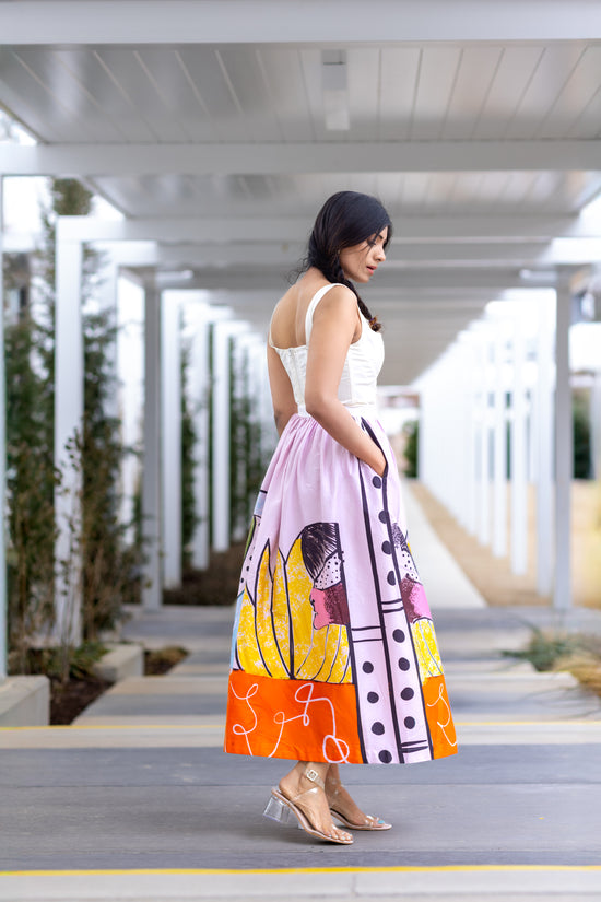 Side profile view of POISE abstract wearable art midi skirt by Ojasi, Luxury designer statement skirt with artistic print and structured silhouette