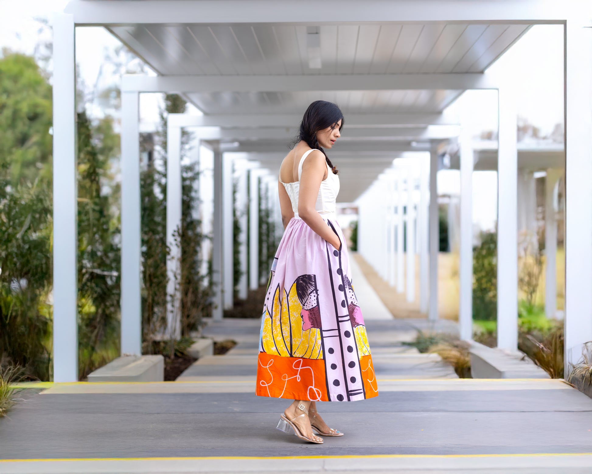 Side profile view of POISE abstract wearable art midi skirt by Ojasi, Luxury designer statement skirt with artistic print and structured silhouette