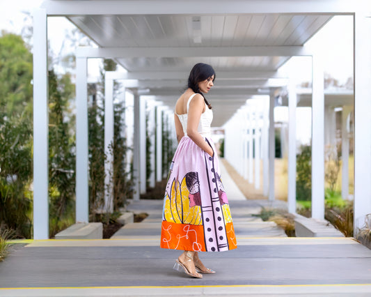 Side profile view of POISE abstract wearable art midi skirt by Ojasi, Luxury designer statement skirt with artistic print and structured silhouette