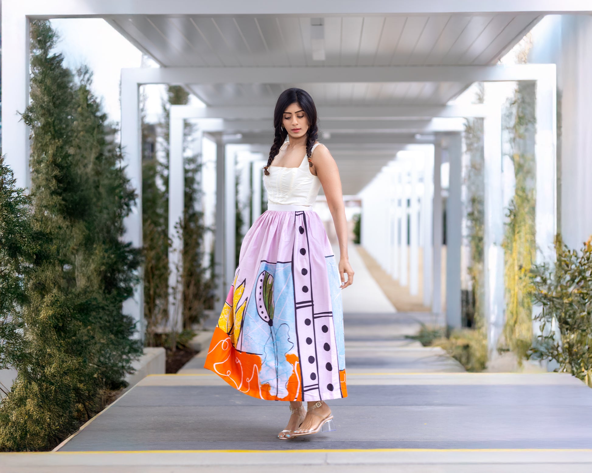 Model walking in POISE abstract wearable art midi skirt by Ojasi, luxury statement skirt for women