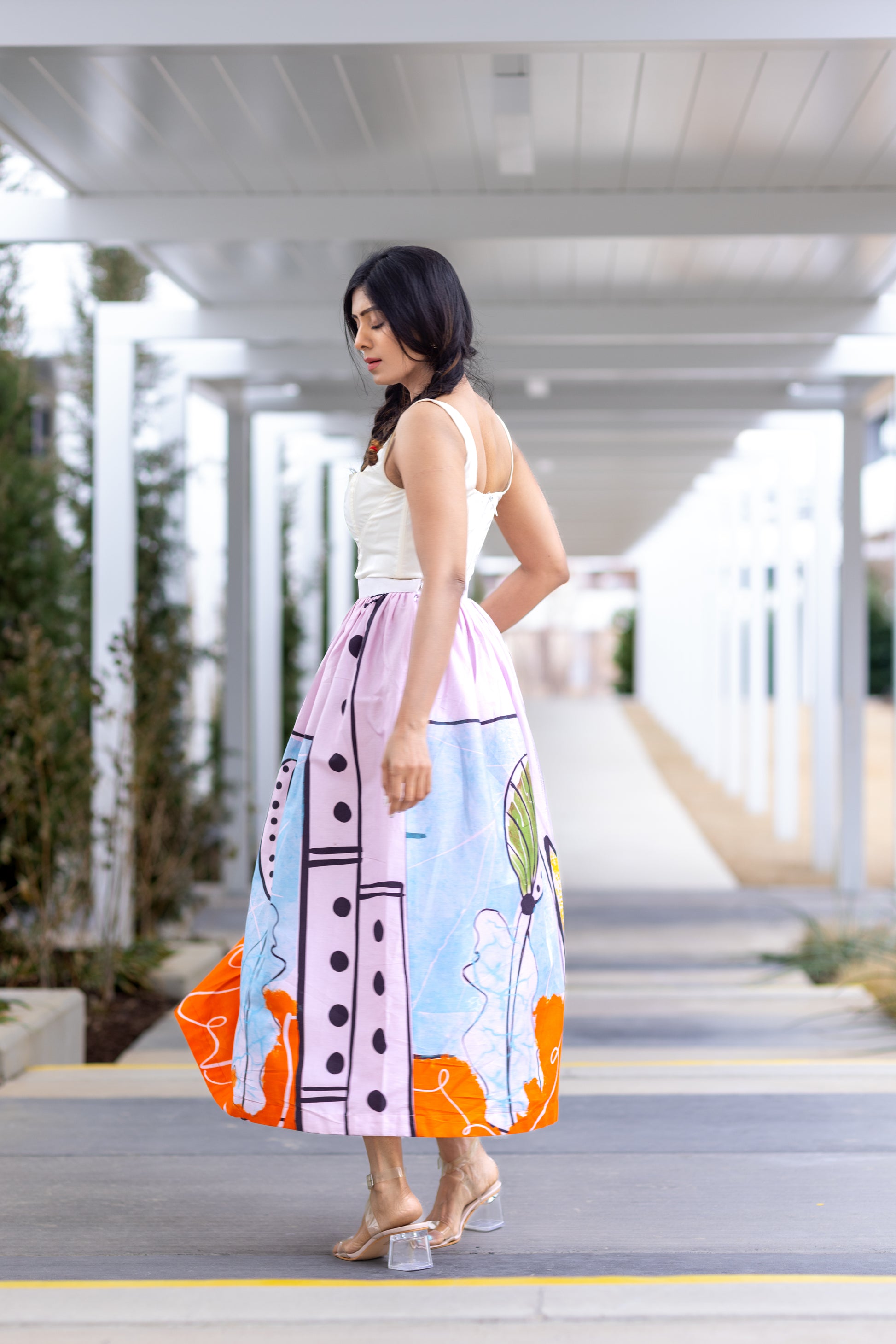 Backview of POISE abstract wearable art midi skirt by Ojasi, luxury designer statement skirt with artistic print