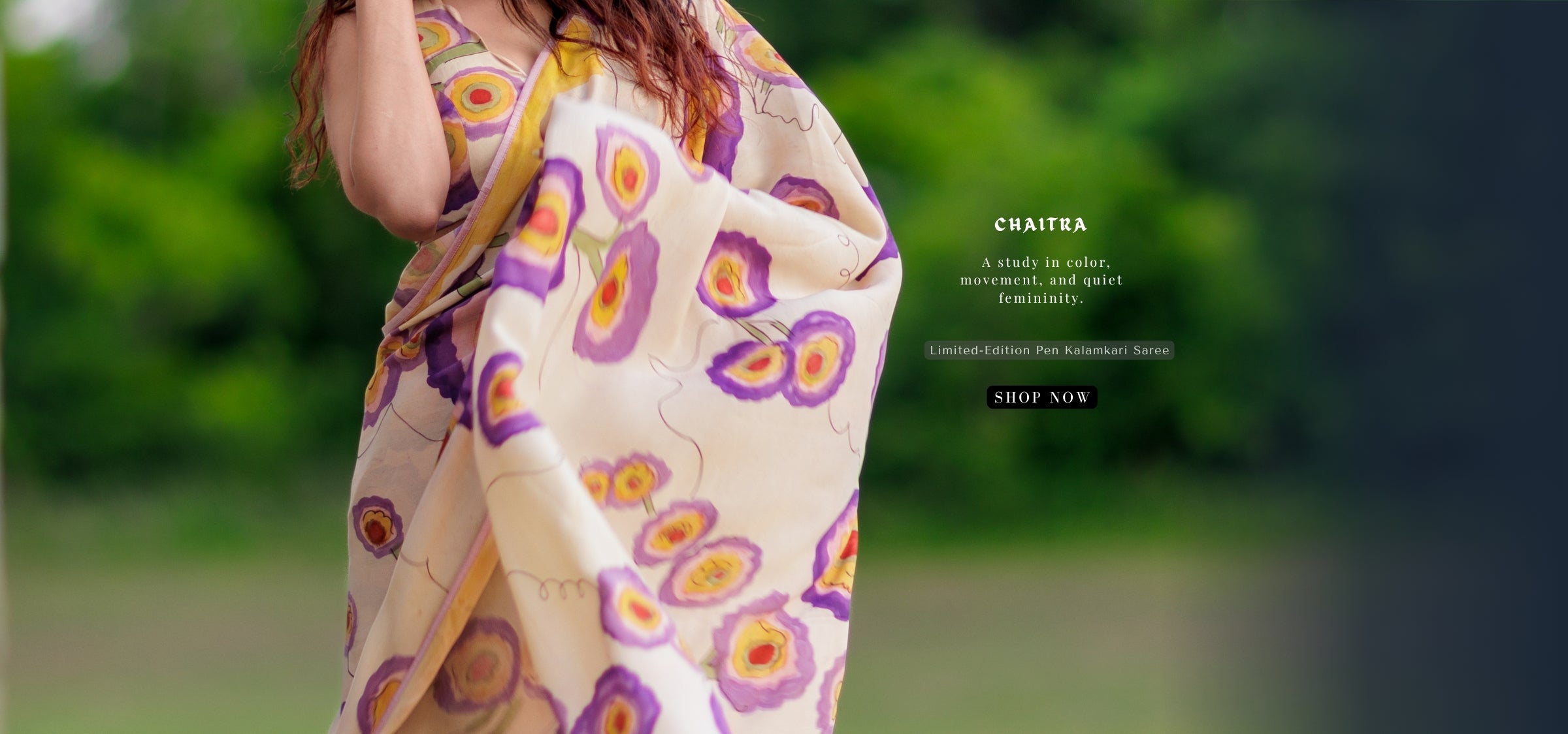 Woman wearing an abstract floral saree handpianted in kalamkari dyes 