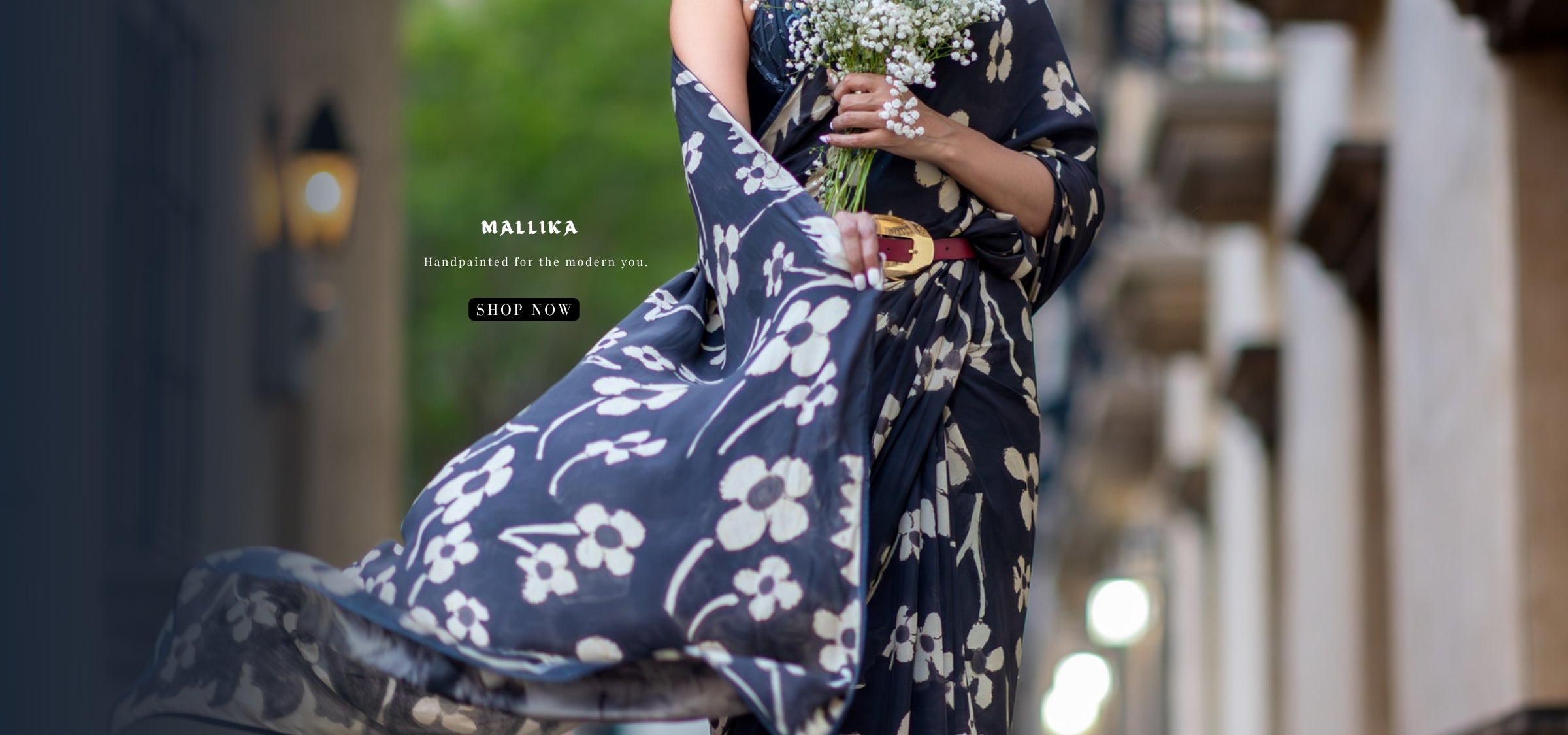 Woman wearing floral designer artisanal saree by Luxury Indian brand in USA