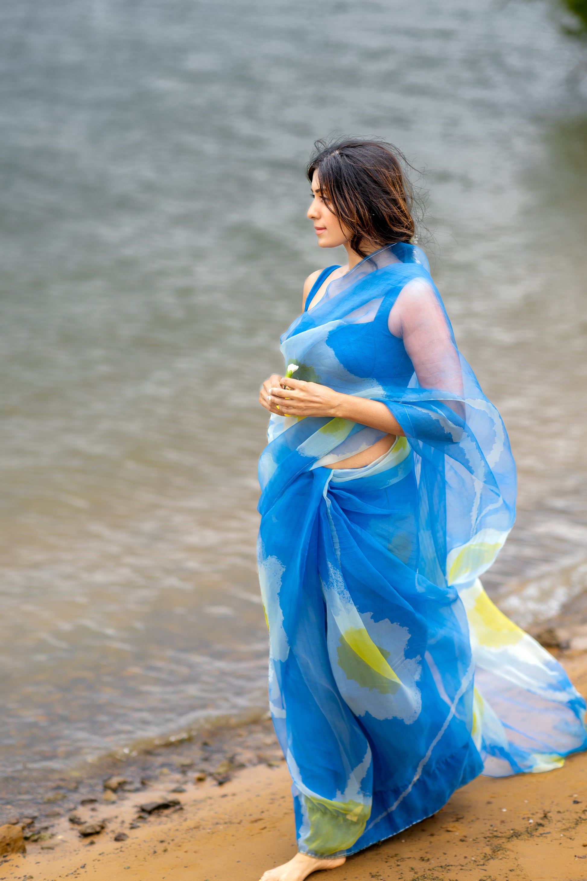 model walking by lake in high end premium editorial abstract saree in Texas