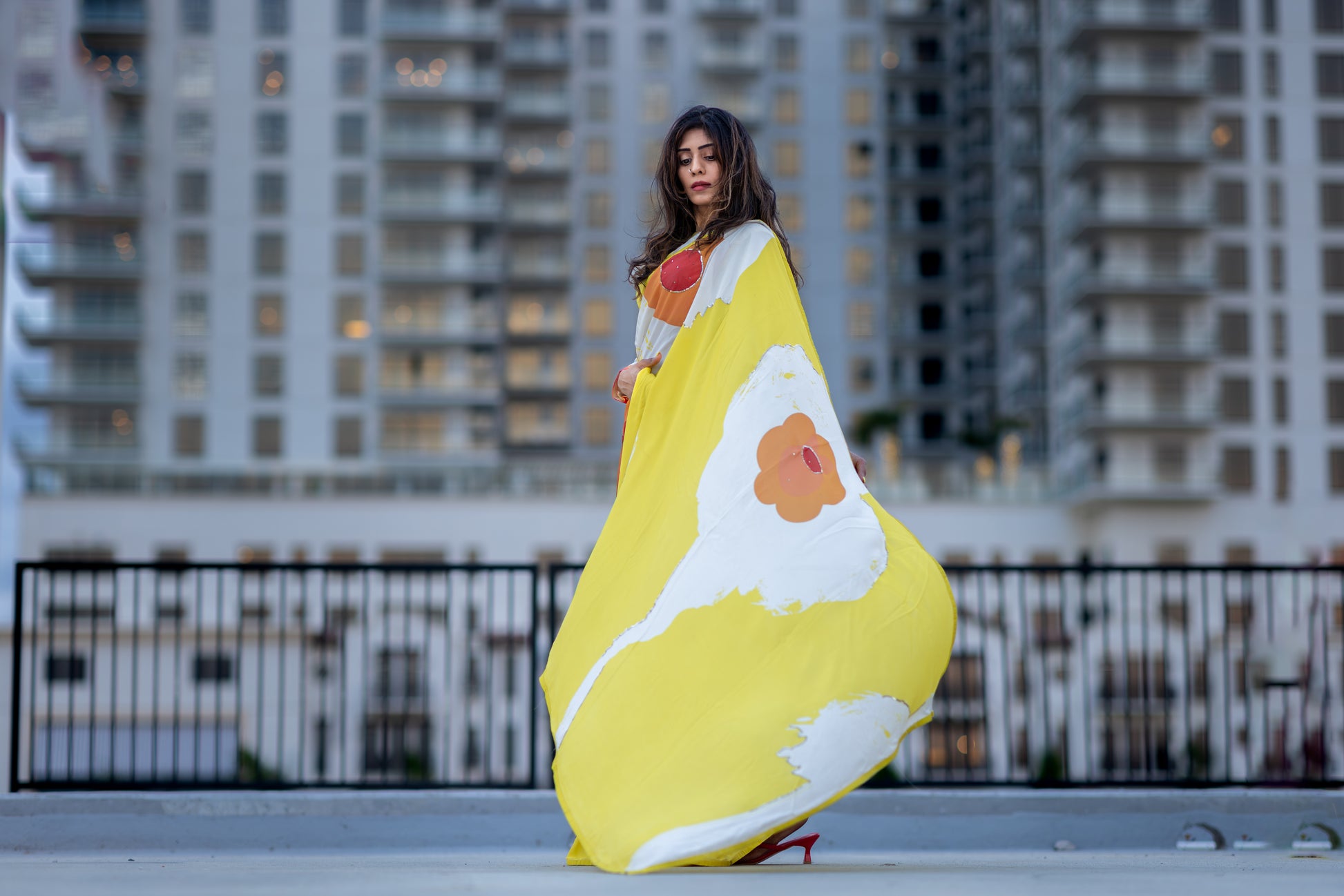 Model posing in Digitally printed georgette saree by Indian designer Ojasi in USA