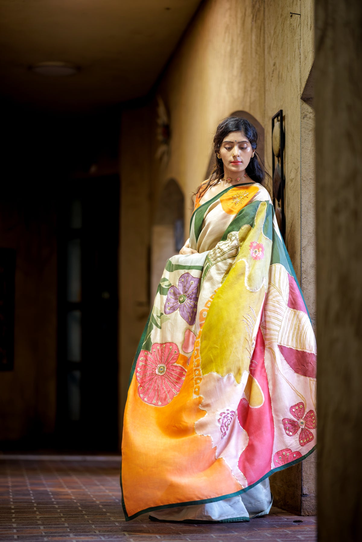 model standing by the wall wearing authentic pen kalamkari saree from ojasi label dallas