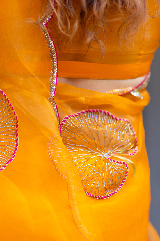 Tamara – Sunkissed Orange Pure Organza Silk Saree with Hand-Embroidered Lotus Leaves & Sequin Pallu