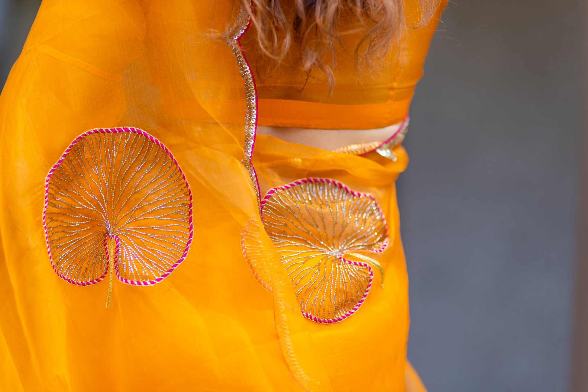 Tamara – Sunkissed Orange Pure Organza Silk Saree with Hand-Embroidered Lotus Leaves & Sequin Pallu