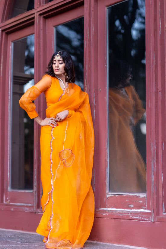 Tamara – Sunkissed Orange Pure Organza Silk Saree with Hand-Embroidered Lotus Leaves & Sequin Pallu