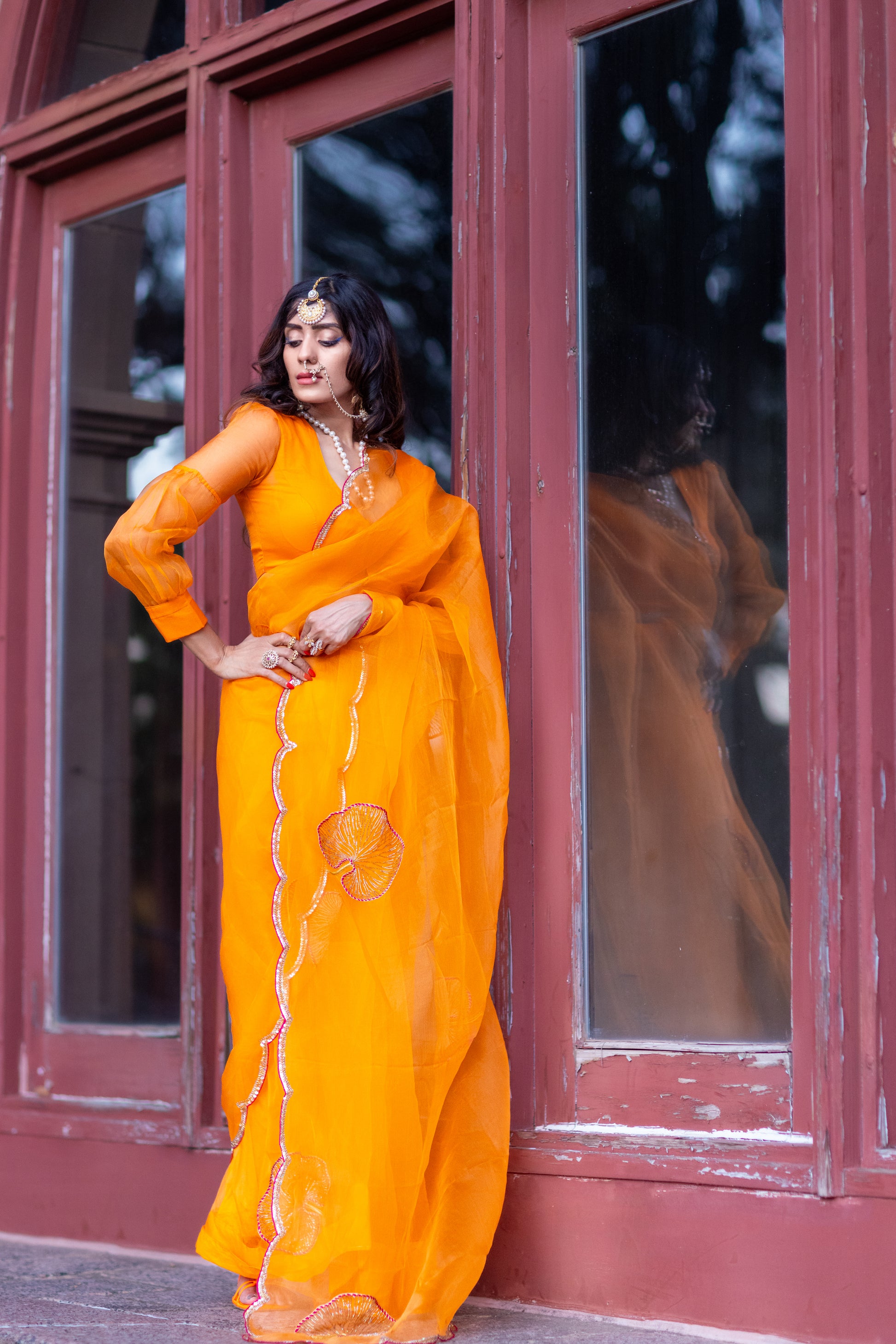 Tamara – Sunkissed Orange Pure Organza Silk Saree with Hand-Embroidered Lotus Leaves & Sequin Pallu