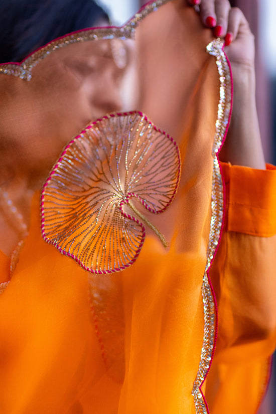 Tamara – Sunkissed Orange Pure Organza Silk Saree with Hand-Embroidered Lotus Leaves & Sequin Pallu