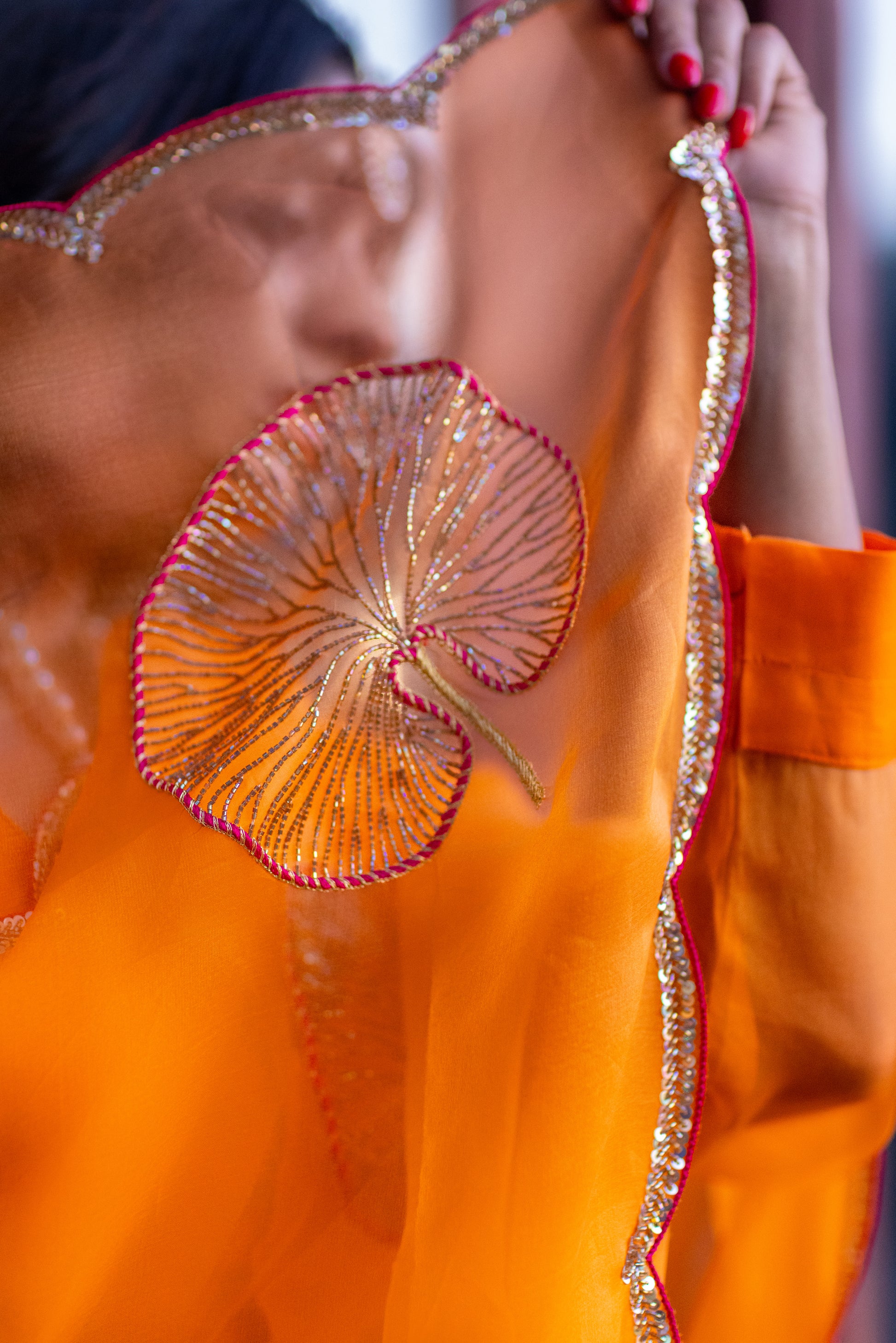 Tamara – Sunkissed Orange Pure Organza Silk Saree with Hand-Embroidered Lotus Leaves & Sequin Pallu